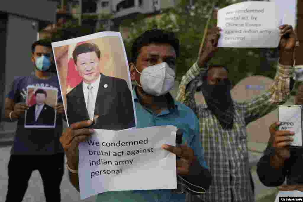 An Indian man holds a photograph of Chinese president Xi Jinping during a protest against China in Ahmedabad, India, Tuesday, June 16, 2020.