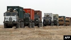 A convoy of British military vehicles moves through southern Afghanistan's Helmand province.