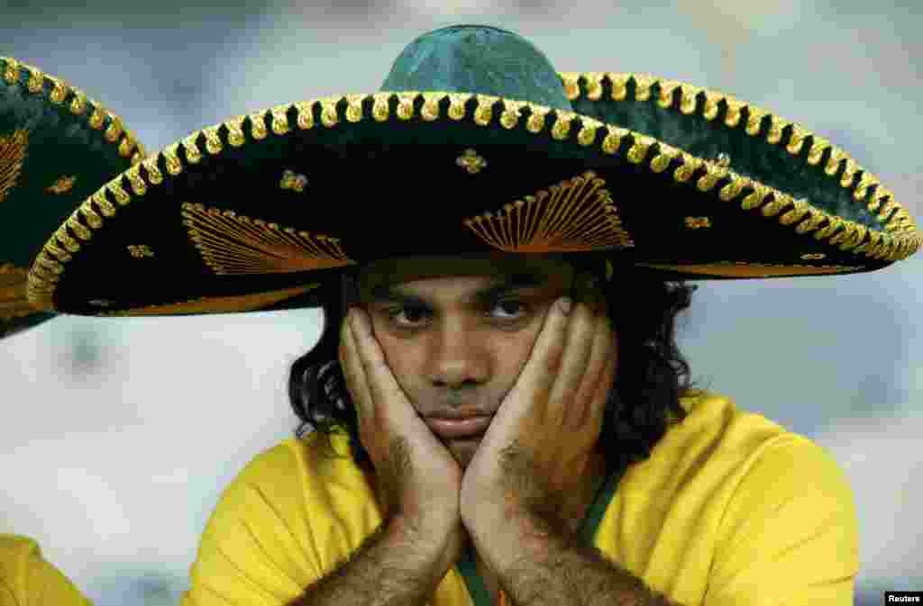 Brazil - A Brazil fan reacts after the team's 2014 World Cup semi-finals against Germany at the Mineirao stadium in Belo Horizonte July 8, 2014. REUTERS/Ruben Sprich (BRAZIL - Tags: SOCCER SPORT TPX IMAGES OF THE DAY WORLD CUP)