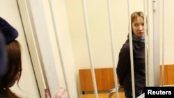 Yekaterina Zaspa, who was a doctor aboard the "Arctic Sunrise" and is one of 30 people arrested over the Greenpeace protest at the "Prirazlomnaya" oil rig, in the dock in St. Petersburg at her November 18 hearing