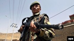 A member of the Afghan security forces stands guard on a roadside after security was increased following reports of Mullah Omar's death.