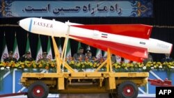 President Mahmud Ahmadinejad (center-left) watches as a Yasser missile is paraded during Army Day celebrations in Tehran.