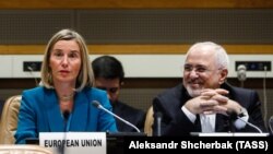 File - EU foreign policy chief Federica Mogherini (left) and Iranian Foreign Minister Mohammad Javad Zarif attend a ministerial meeting of the P5+1 countries and Iran held on the sidelines of the 73rd session of the UN General Assembly, September 2018.
