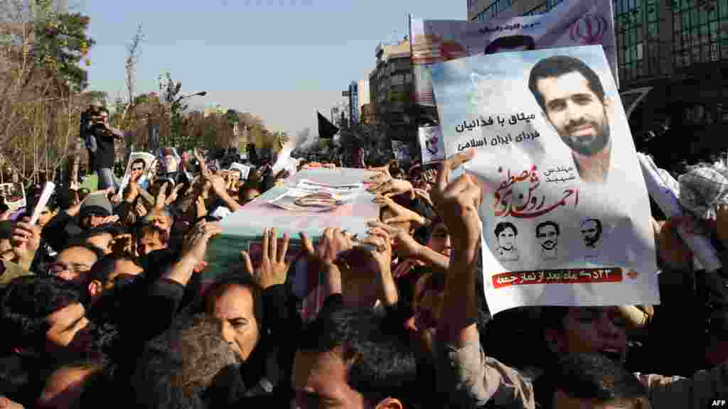 Mourners carry the coffin of Iranian nuclear scientist Mostafa Ahmadi Roshan during his funeral in Tehran on January 13. Roshan was killed the previous day when two men on a motorbike slapped a magnetic bomb on his car while it was stuck in Tehran traffic. (AFP/Atta Kenare)