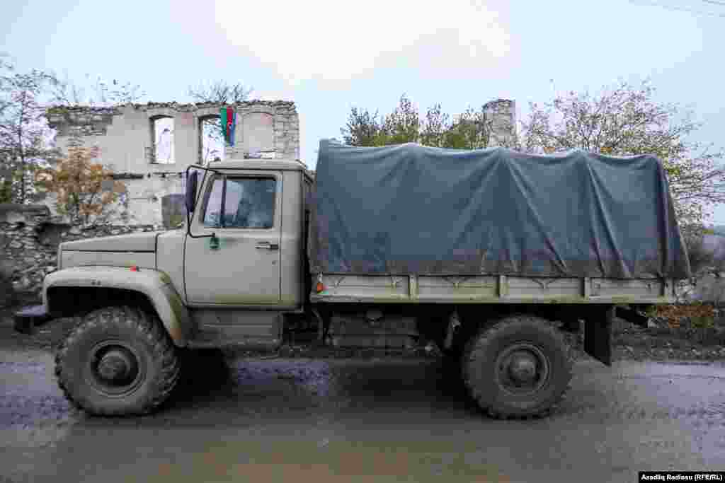 NAGORNO-KARABAKH -- A vehicle near the ruins of a destroyed house in the town of Fuzuli. November 19, 2020