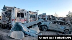 Damaged vehicles are seen at the site of a car bombing in Qalat, capital of Zabul Province, on September 19.