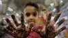 A young girl in Peshawar, Pakistan, applies a henna design on her hands ahead of the Eid al-Fitr festival marking the end of Ramadan. (epa/Bilawal Arbab)