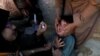 FILE: A boy reacts as he is being administered polio vaccine drops by anti-polio vaccination workers in Quetta, the capital of southwestern Balochistan province.