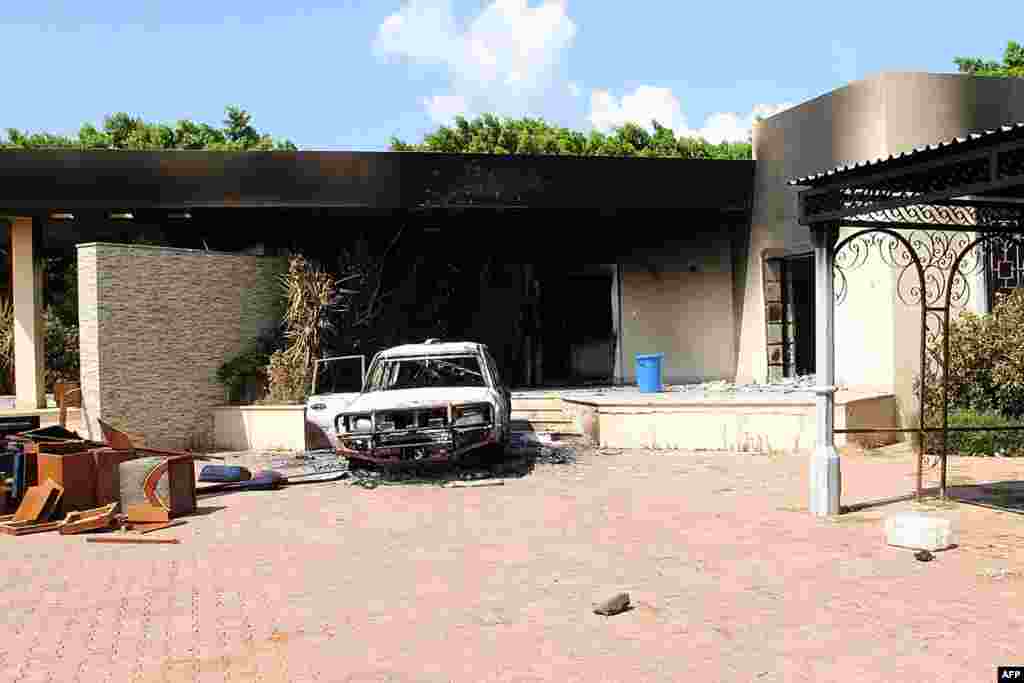 A burned house and car are seen inside the U.S. Consulate compound.