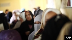 Egyptian women queue at a polling station in central Cairo to cast their vote on a new constitution supported by the ruling Islamists but bitterly contested by a secular-leaning opposition on December 15.