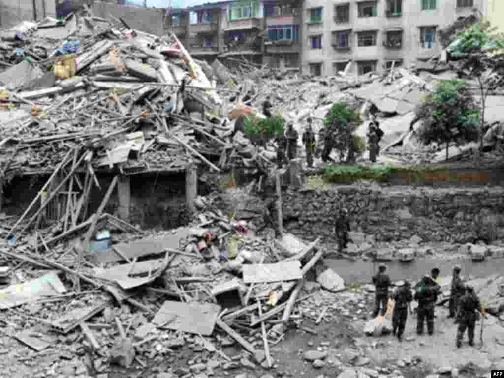 China -- Rescuers search a collapsed building for survisors in Beichuan, Sichuan province, 13May2008