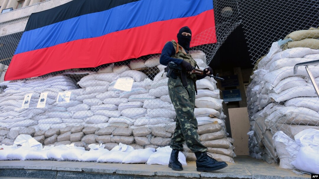 An armed man in military fatigues stands guard outside a regional administration building seized by the separatists in the eastern Ukrainian city of Slovyansk on April 23.