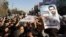 Mourners carry the coffin of Mostafa Ahmadi Roshan during his funeral in Tehran on January 13. Roshan is the fourth Iranian nuclear scientist to be assassinated in two years. Iran accuses Azerbaijan of colluding with Israel in the killings.