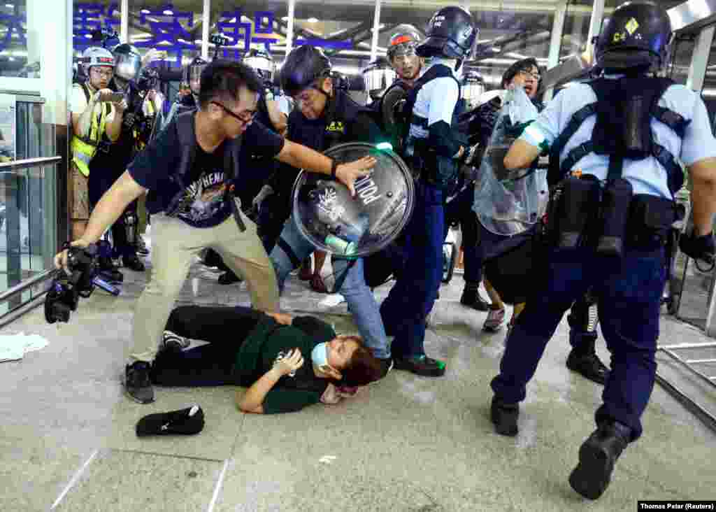 Riot police disperse pro-democracy protesters at Hong Kong International Airport. The protests were sparked by opposition to a plan to allow extraditions to the mainland but have since morphed into a wider call for democratic rights in the semiautonomous city. (Reuters/Thomas Peter)