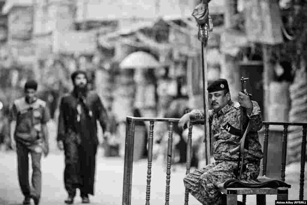 A soldier stands guard at a checkpoint in Karbala, one of countless security points in Iraq.