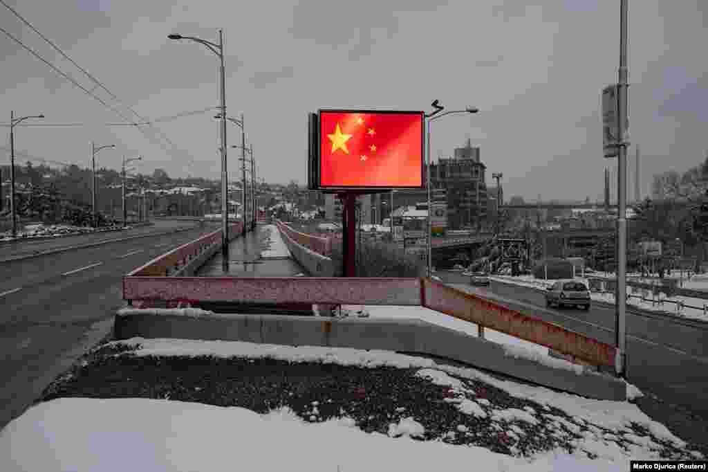 A screen shows a rippling Chinese flag in the Serbian capital, Belgrade. This is one of several displays of pro-Chinese messaging installed across Serbia during the coronavirus pandemic.