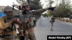 Afghan special forces patrol a deserted street during fighting with the Taliban in Lashkar Gah on August 3.