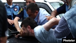 Armenia - Hayk Kyureghian is overpowered by police officers after firing gunshots outside a court in Yerevan, 12Jun2014.