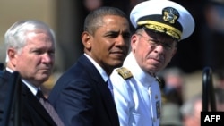 U.S. President Barack Obama (center) was flanked at a tribute in June by outgoing Defense Secretary Robert Gates (left) and Admiral Mike Mullen, both of whom concluded the repeal wouldn't harm the military.