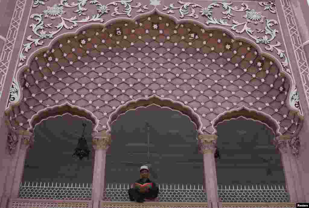 A Pakistani youth recites the Koran during the Muslim holy month of Ramadan at the Mahabat Khan mosque in Peshawar on July 17. (Reuters//Fayaz Aziz)