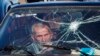 A passenger waits as his car is searched at a checkpoint while leaving Nagorno-Karabakh on November 8.&nbsp;