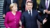 French President Emmanuel Macron (right) and German Chancellor Angela Merkel pose for a family photo with members of their cabinets during a meeting in Toulouse, France, on October 16.