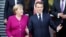 French President Emmanuel Macron (right) and German Chancellor Angela Merkel pose for a family photo with members of their cabinets during a meeting in Toulouse, France, on October 16.