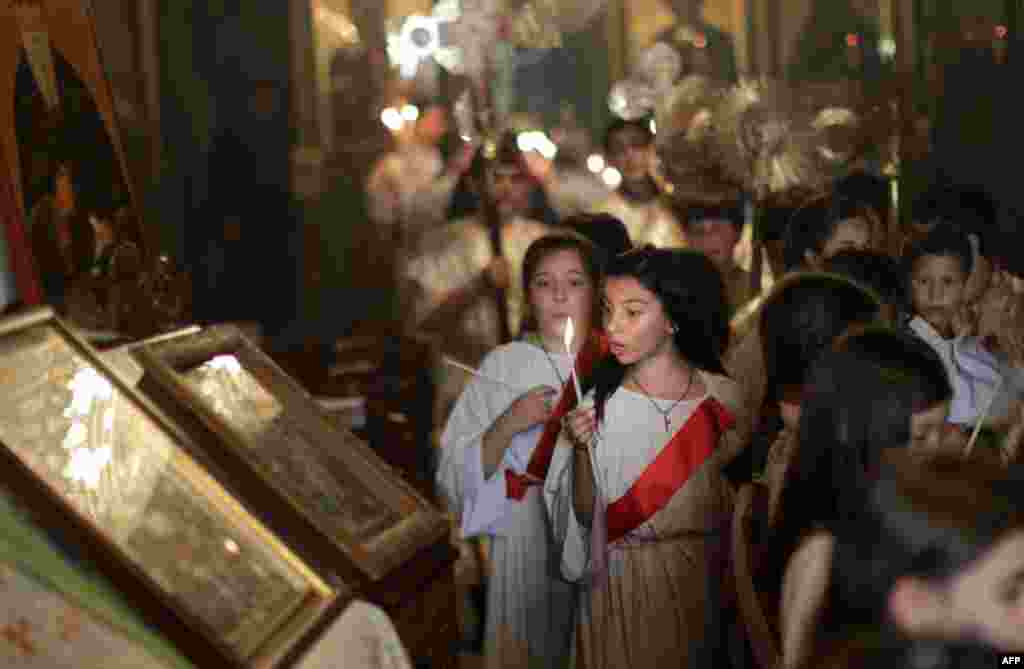 Palestinian Orthodox Christians attend a Palm Sunday procession at a church in Gaza City. (AFP/Mahmud Hams)