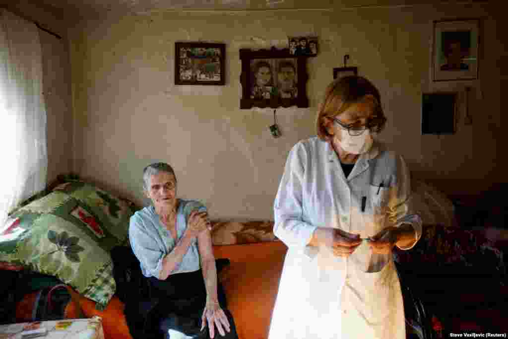 A medical worker prepares an injection as an elderly villager waits.&nbsp; As of May 12, a little over 5 percent of the population of Montenegro had been fully vaccinated.&nbsp;