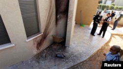 A policewoman looks at the damage after a rocket fired by Palestinian militants in Gaza landed in the southern town of Sderot on March 21.