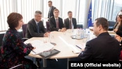 European Union foreign policy chief Catherine Ashton (left) meets with Serbian and Kosovar Prime Ministers Hashim Thaci (second from left) and Ivica Dacic (right front) in Brussels on March 4.