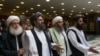 FILE: Mullah Abdul Ghani Baradar, a top Taliban leader, second from left, arrives for talks in Moscow in May 28.