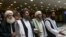 FILE: Mullah Abdul Ghani Baradar, a top Taliban leader, second from left, arrives for talks in Moscow in May 28.