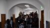 Russian law enforcement officers stand guard as journalists wait for suspects in the deadly attack on the Crocus City Hall to appear at the Basmanny District Court in Moscow on March 24, 2024.