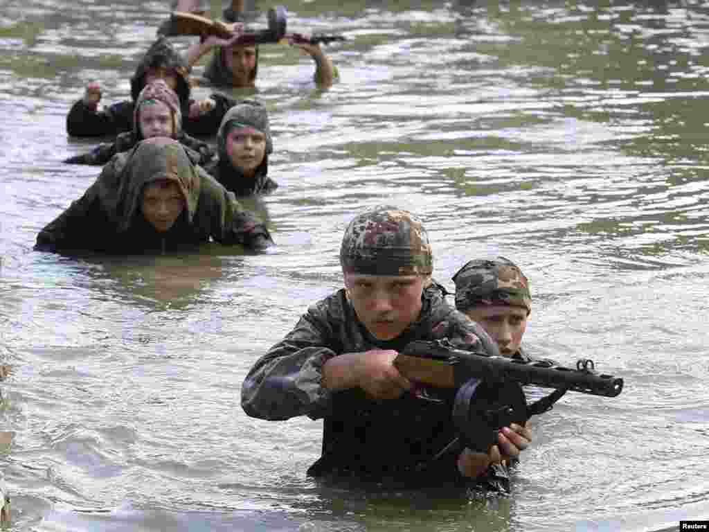 Teenagers undergo training at a military boot camp run by local Cossack organizations and set up in the mountains of Crimea near the town of Bakhchisarai. Some 100 youngsters from Russia, Belarus, and Ukraine, as well as the Georgian breakaway regions of Abkhazia and South Ossetia, have taken part in the training course, which lasts for about a month and includes mountaineering, martial arts, and survival techniques.Photo by Gleb Garanich for Reuters