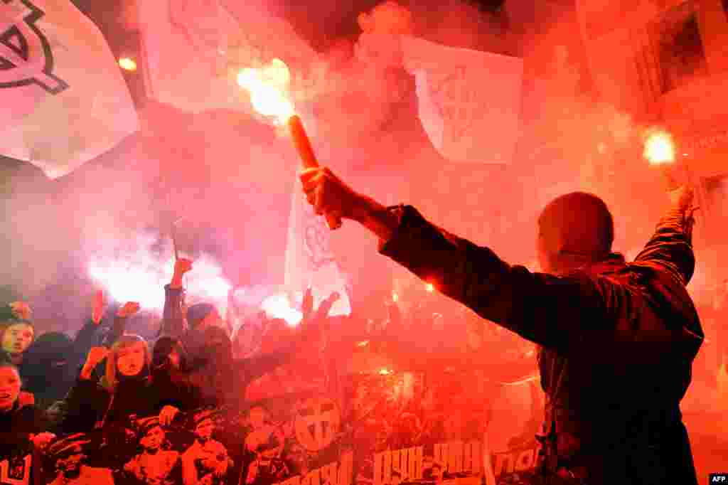 Young Ukrainian ultranationalists hold flares and shout slogans during a march in Kyiv. (AFP/Sergei Supinsky)