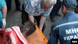 Rescue workers carry an injured miner out of the Skochynsky mine.