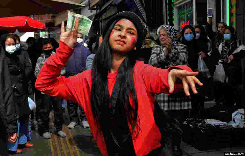 An Iranian girl wearing a costume inspired in the fictional folklore character Hajji Firuz dances in Tehran on March 17, as Iranians prepare to celebrate Norouz, the Iranian new year. (AFP/Atta Kenare)