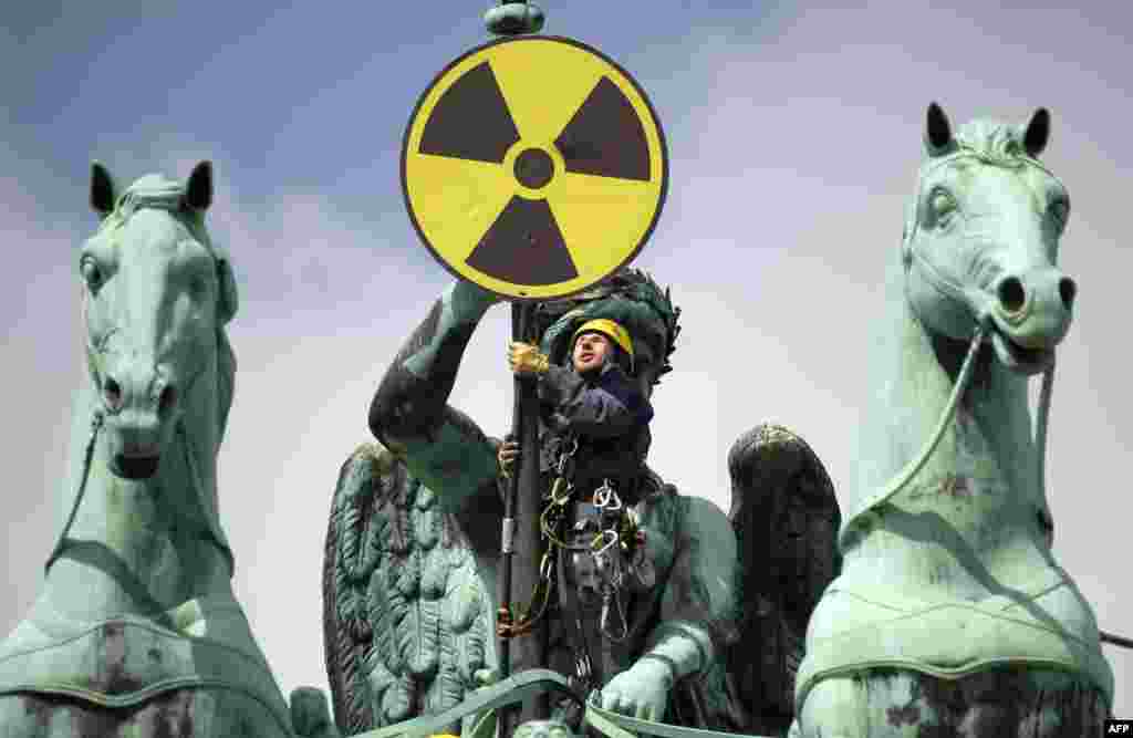Greenpeace antinuclear protesters scale the top of the Brandenburg Gate in Berlin during a demonstration on May 29.Photo by Odd Andersen for AFP