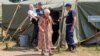 Internally displaced Ukrainians are assisted at a temporary camp for people from Svatovo, in Luhansk region, on August 12.