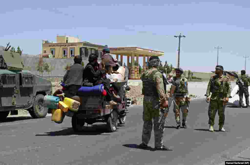 People flee the northwestern Afghan city of Herat as government troops patrol the streets. Afghan security forces took back parts of the city following intense battles with Taliban fighters on August 8.