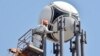 A worker finalizes the painting of a cell-phone tower where a football has been set up in Kyiv ahead of the 2018 UEFA Champions League final football match between Real Madrid and Liverpool on May 26.