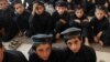 Boys attend a class at a school in a tribal agency in Pakistan's rugged northwest, where the goverment's battle with militants has destroyed the local econmy.