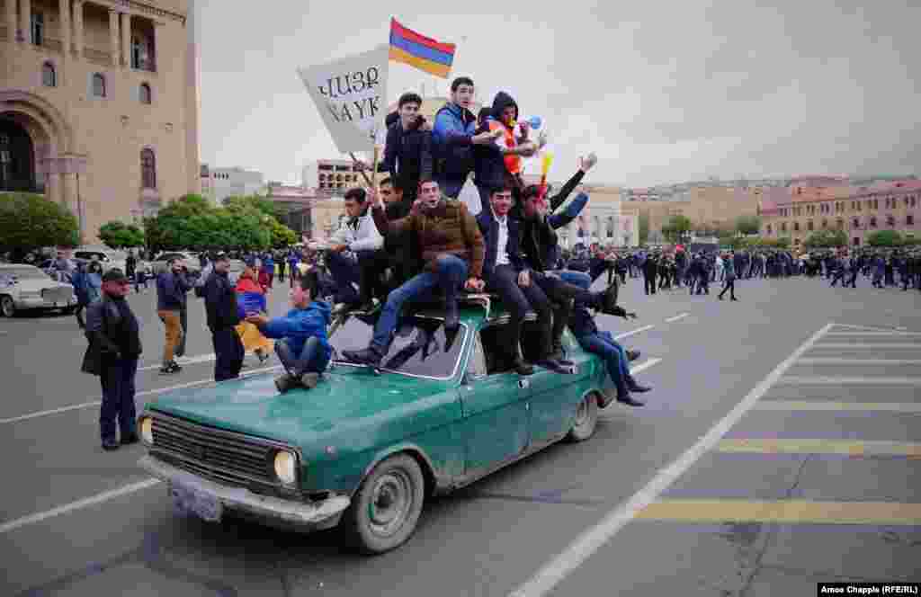 Protesters from Vayk, in southeast Armenia, pile atop a car on Republic Square in Yerevan on April 21. The square was full of people after different marches met in the city center.