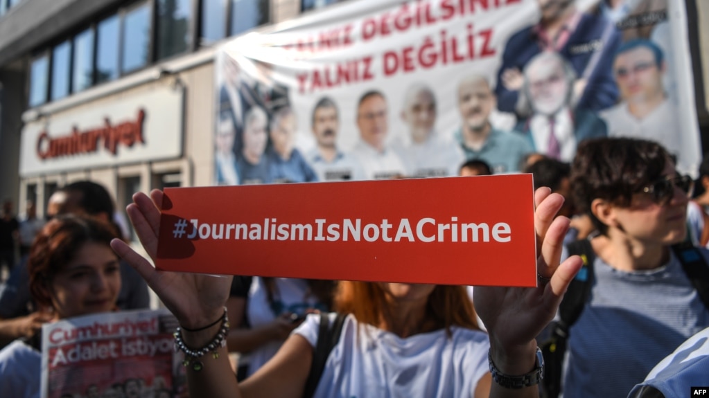A journalist holds up a banner outside the headquarters of opposition newspaper Cumhuriyet in Istanbul during a protest in July.