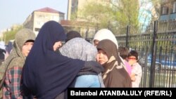 Onlookers outside wait outside the court in Atyrau.