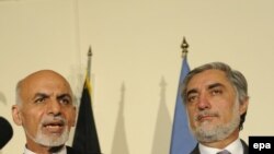 Afghanistan -- Presidential Candidates Ashraf Ghani (L) and Abdullah Abdullah speak to journalists during a press conference with US Secretary of State and UN special representative to Afghanistan, in Kabul, July 12, 2014