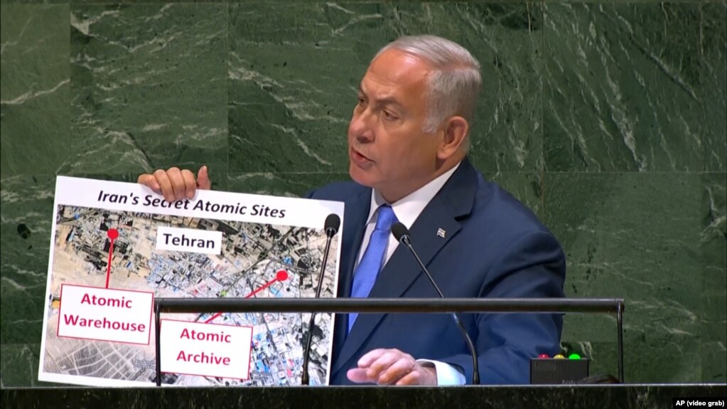 Israeli Prime Minister Benjamin Netanyahu holds up a poster at the UN General Assembly showing an alleged secret atomic warehouse near Tehran.