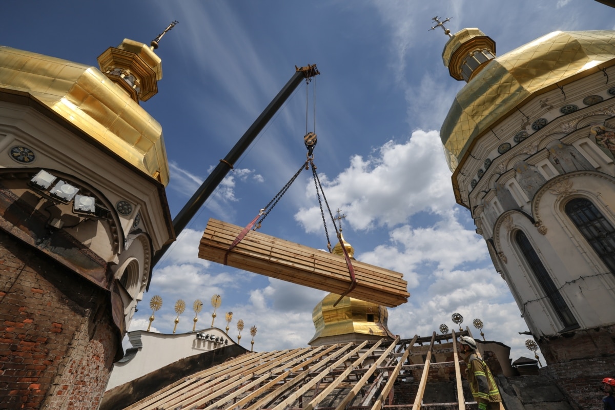 Рятувальники другий день поспіль встановлюють аварійне накриття над Успенським собором Києво-Печерської лаври, щоб захистити його від дощів та подальших руйнувань, Київ, 17 червня 2026 року