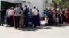 People line up outside a food store in Ashgabat to buy subsidized vegetable oil, sugar, and flour -- whie it lasts. 